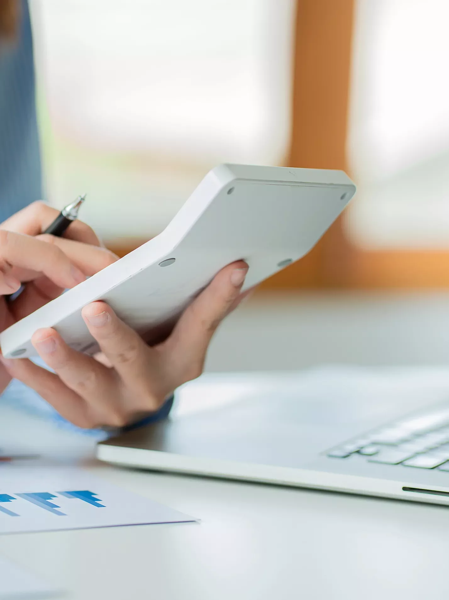Hands holding a calculator auditing
