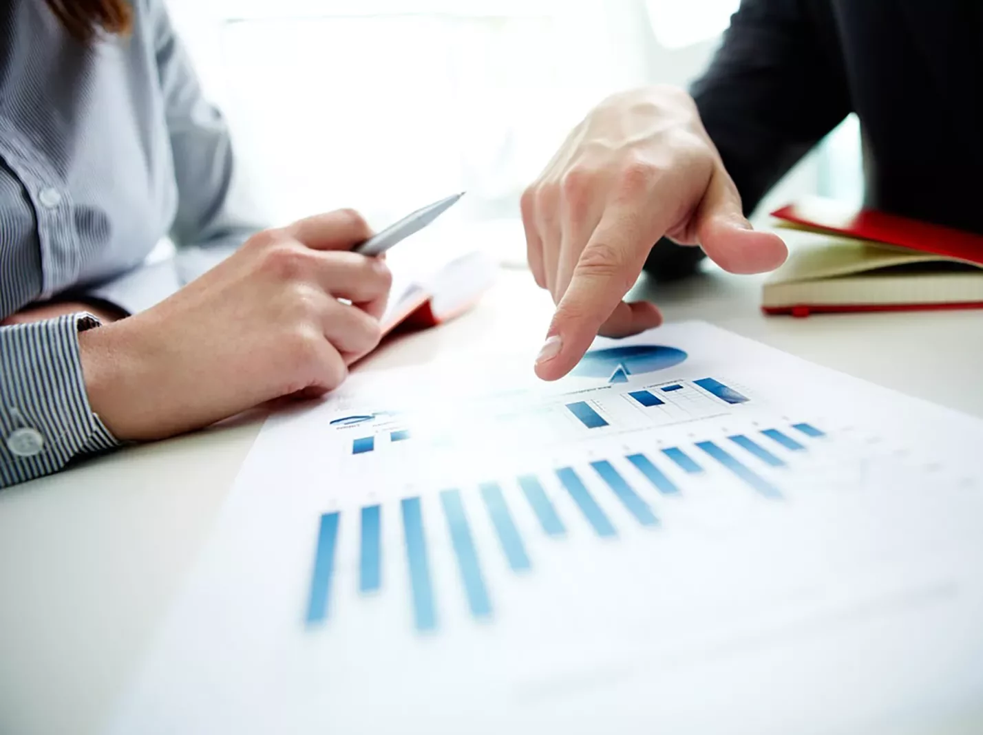 Hand pointing to graph