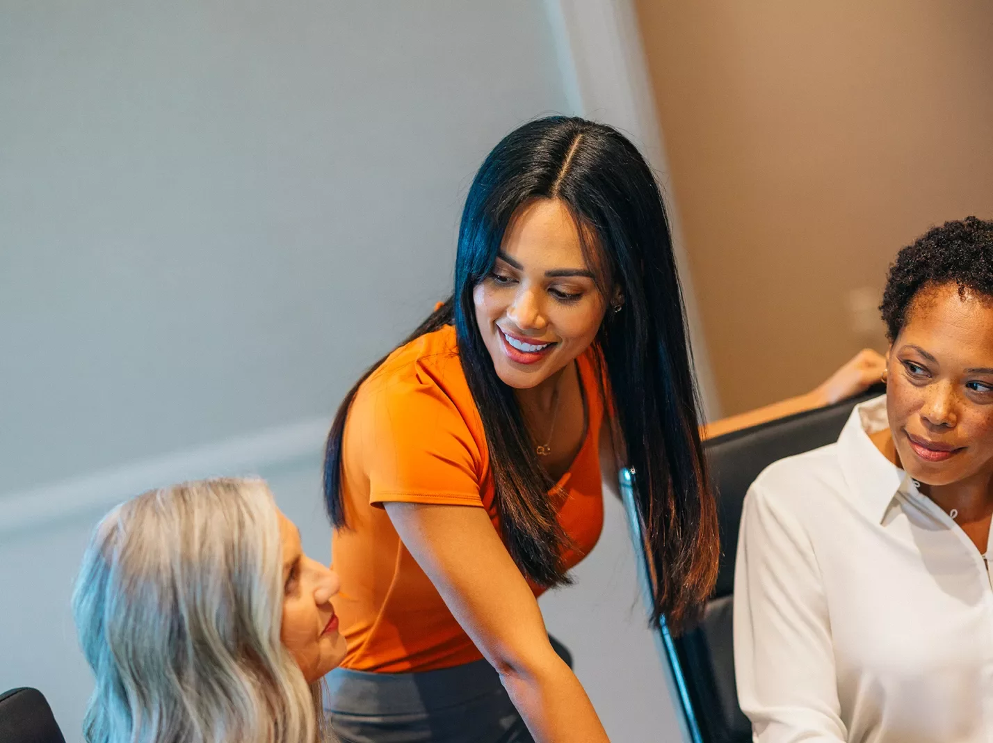 Three women meeting in a conference room