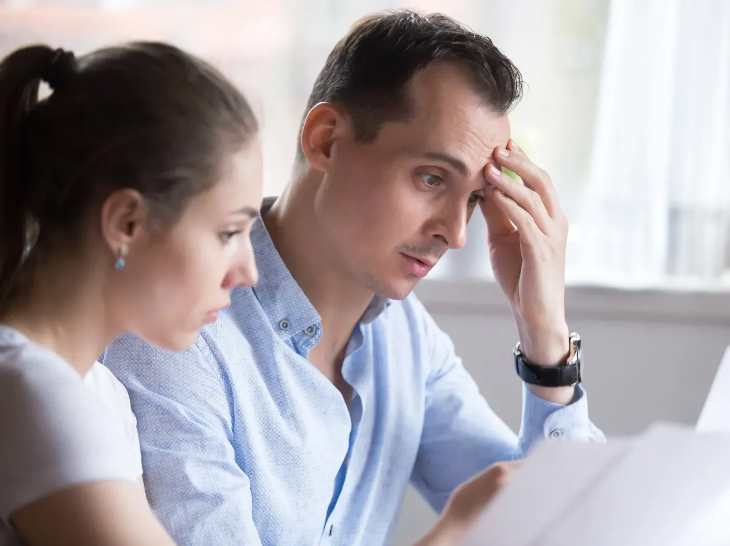 A man and a woman sitting reviewing paperwork