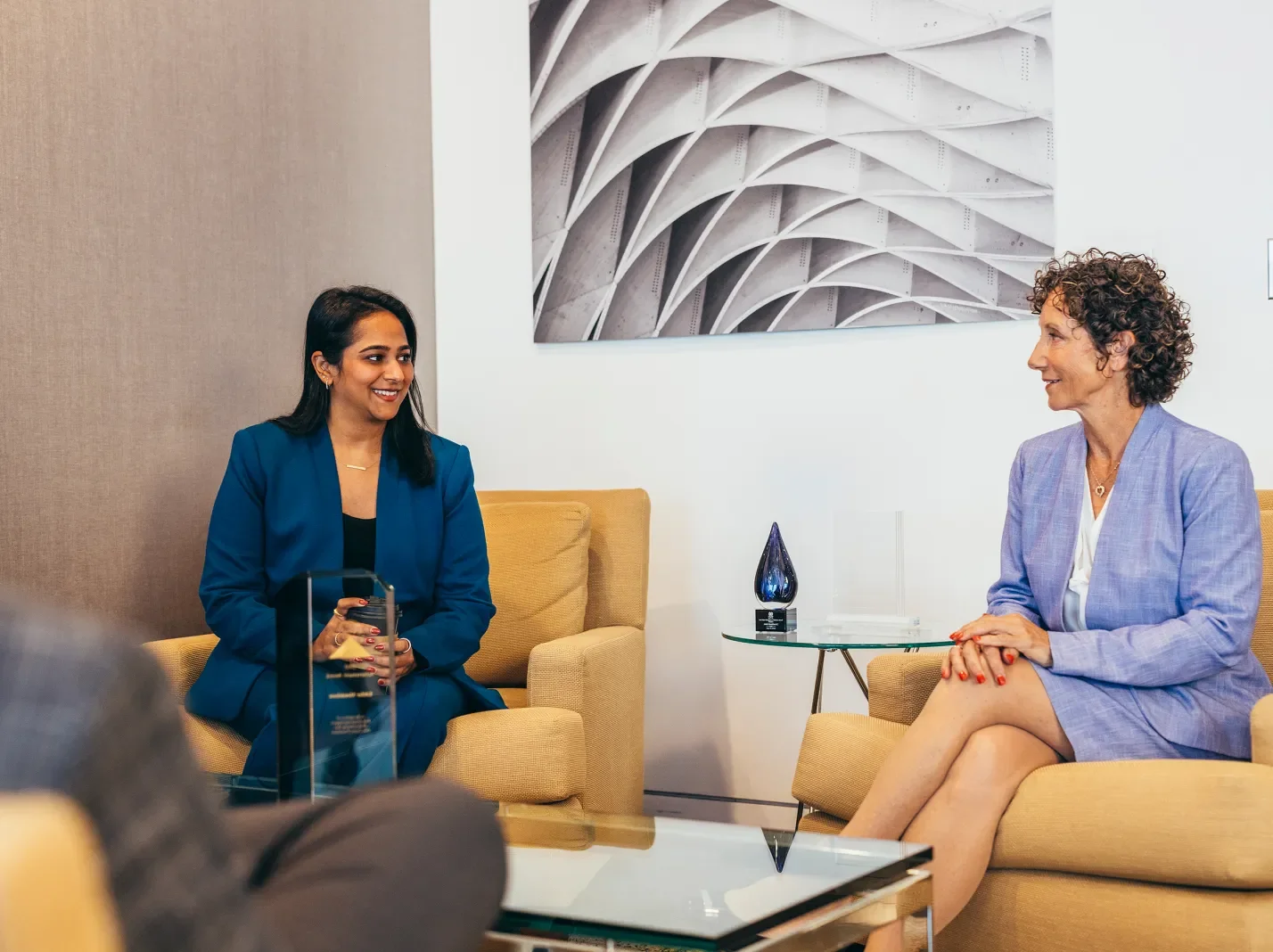 Two women in business attire sitting in Littler office space