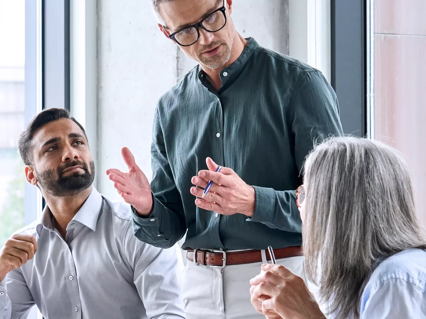 Workplace training three people at a table in conversation