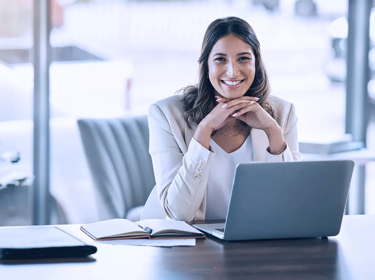 Woman at a laptop smiling virtual workplace training