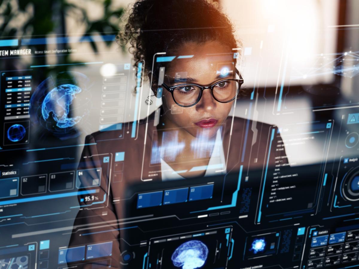 AI and technology - woman working at a computer with digital overlay