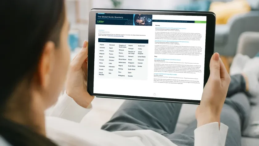 Woman reading Littler's Global Guide Quarterly on a tablet screen