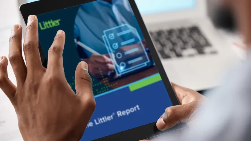 A man reads a Littler Report on a tablet