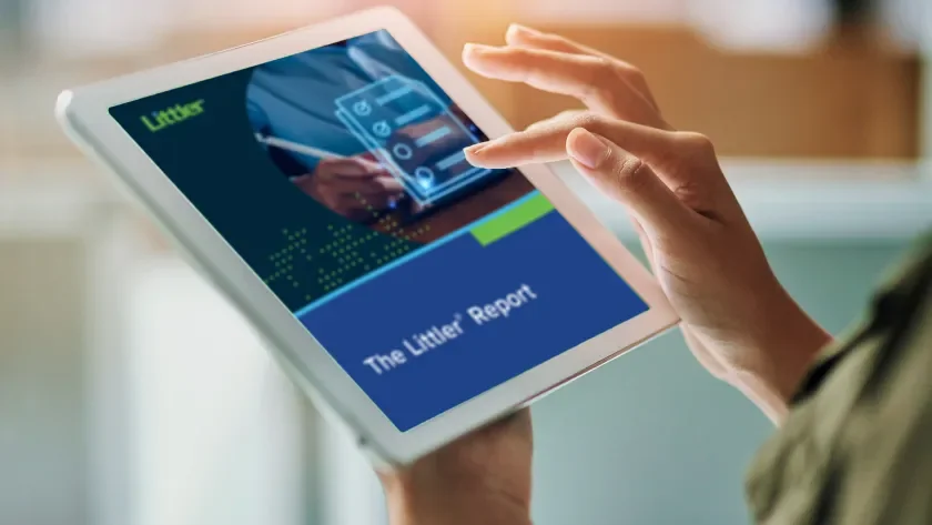 A woman reading a Littler Report on a tablet
