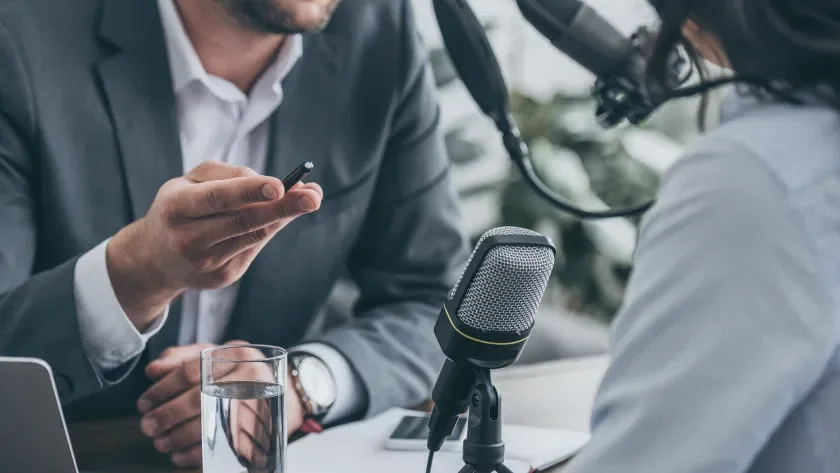 Podcast interview man and woman at microphone