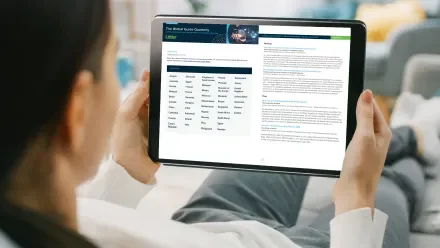 Woman reading Littler's Global Guide Quarterly on a tablet screen