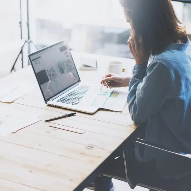 Woman on phone at laptop