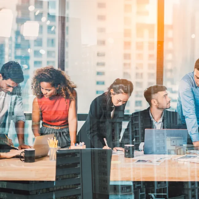 Diverse group of business professionals sitting at a conference table