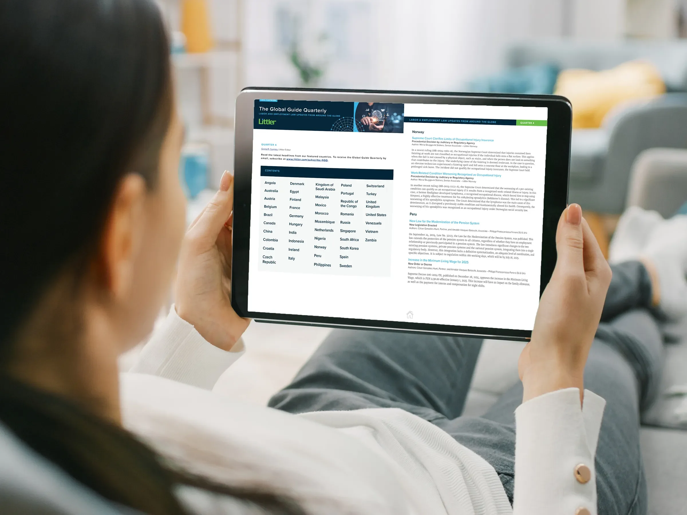 Woman reading Littler's Global Guide Quarterly on a tablet screen